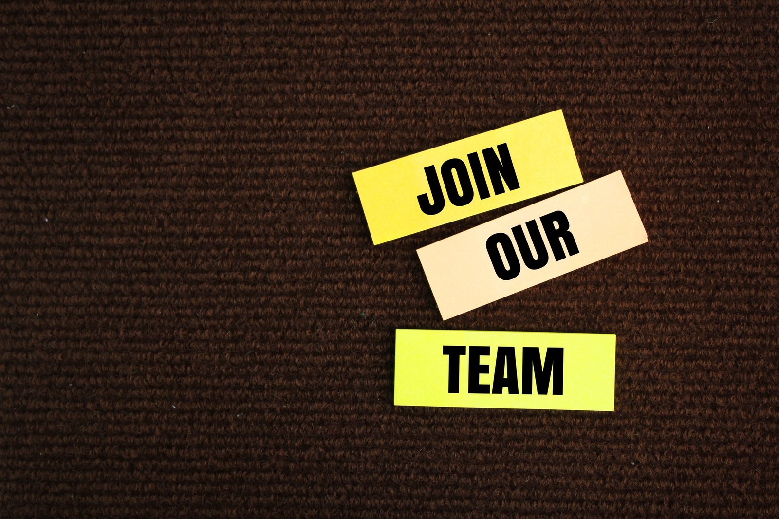 colored paper with the words Join Our Team. teamwork concept.